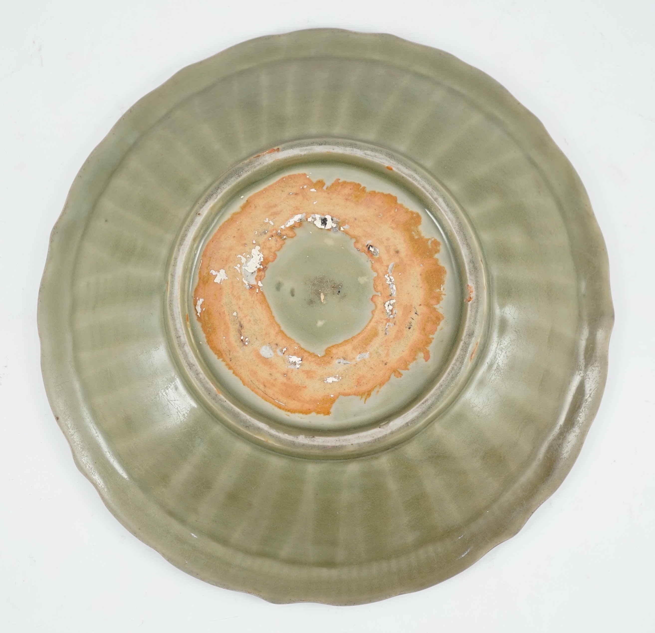 A Chinese Longquan celadon barbed rim dish, 15th century, 26.5cm wide, wear to glaze